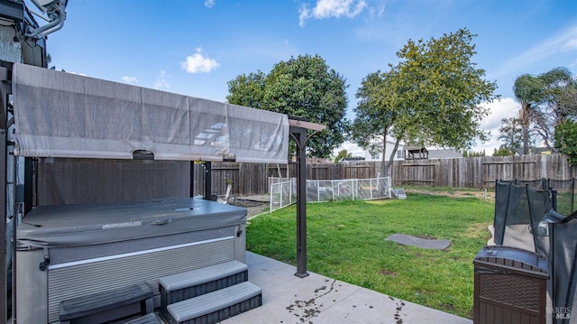 view of yard with a patio, a hot tub, and a fenced backyard