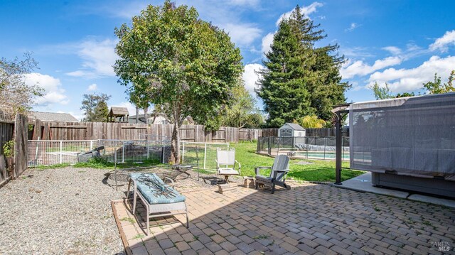 view of patio / terrace featuring an outbuilding, a fenced in pool, and a fenced backyard