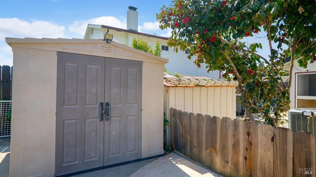 view of shed featuring fence