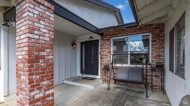 entrance to property with brick siding