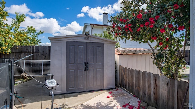 view of shed with fence