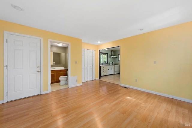 unfurnished living room with baseboards, light wood-style floors, and visible vents