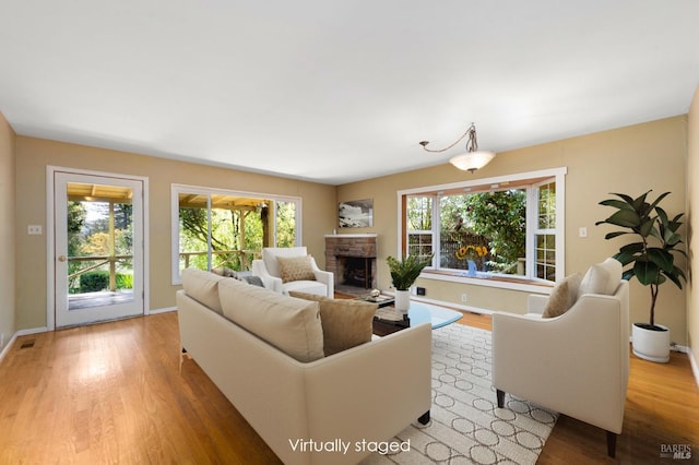 living area featuring wood finished floors and a healthy amount of sunlight