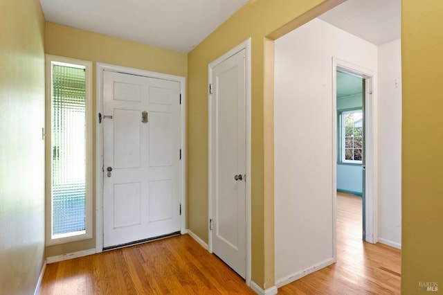 foyer featuring light wood-type flooring and baseboards