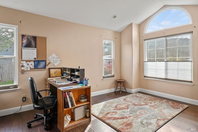 home office featuring vaulted ceiling, plenty of natural light, and wood finished floors