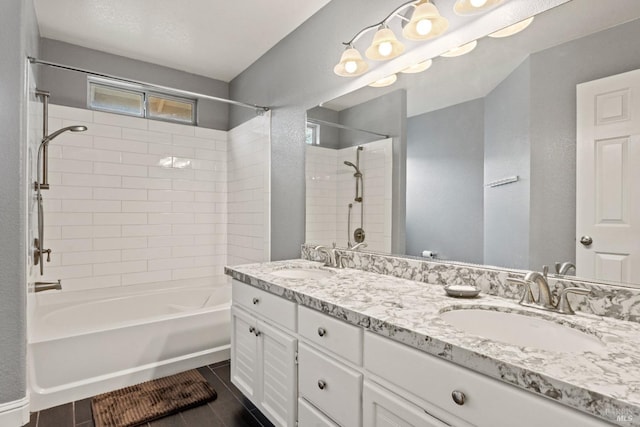 bathroom with double vanity, tile patterned flooring, shower / bathing tub combination, and a sink