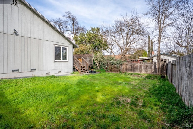 view of yard featuring stairway, a deck, and a fenced backyard