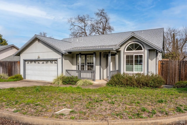 single story home with an attached garage, fence, driveway, and a shingled roof