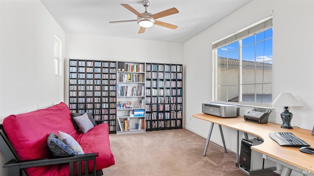 living area featuring a ceiling fan and carpet flooring