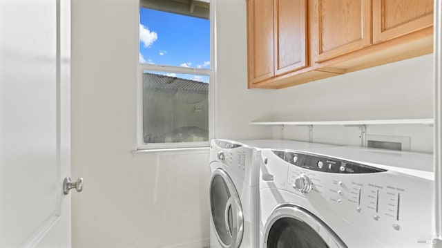 washroom featuring washer and dryer and cabinet space