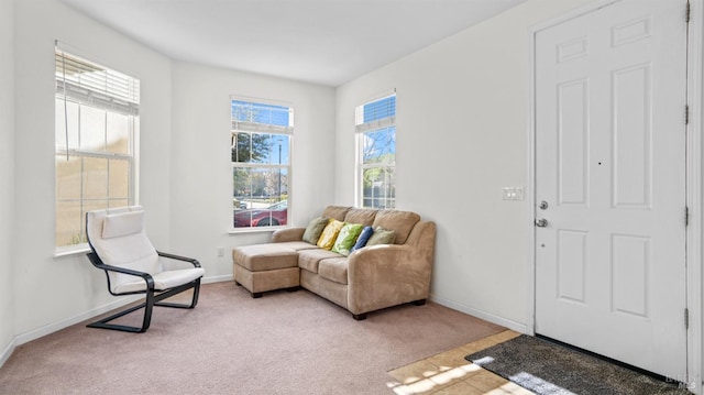 sitting room featuring baseboards and carpet