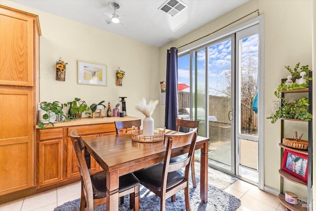 dining area featuring light tile patterned floors and visible vents