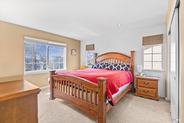 bedroom with recessed lighting, light colored carpet, and baseboards