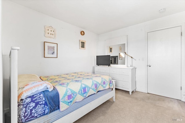 bedroom featuring light colored carpet