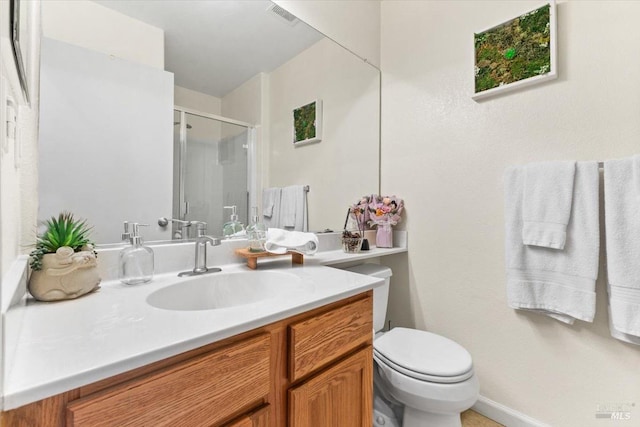 bathroom featuring visible vents, a stall shower, toilet, and vanity