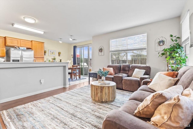 living area with wood finished floors and baseboards