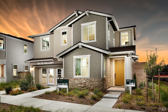 craftsman-style home featuring stone siding