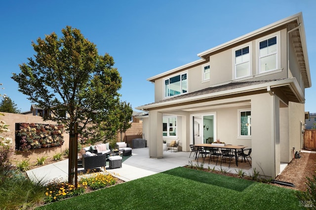 back of house featuring stucco siding, outdoor lounge area, a patio, and fence