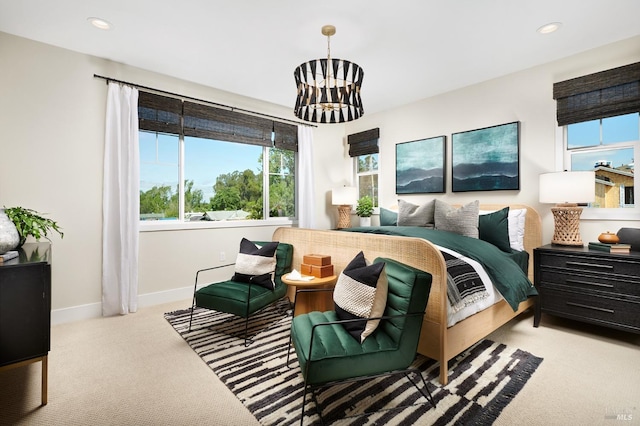 carpeted bedroom with a chandelier, recessed lighting, and baseboards