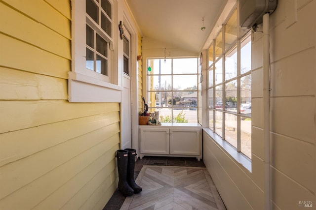 unfurnished sunroom featuring lofted ceiling