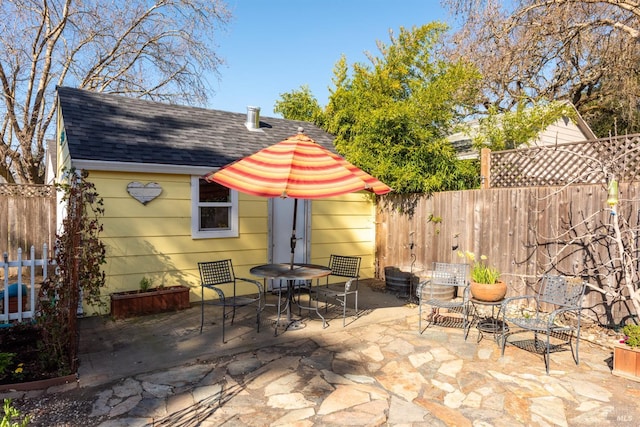 view of patio featuring outdoor dining area and fence