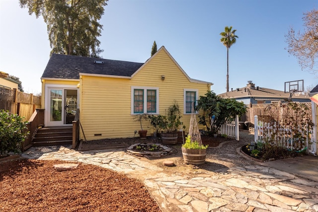 view of front of property with crawl space, entry steps, and fence