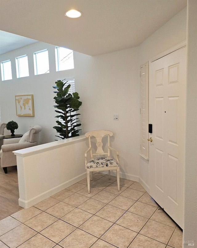 foyer entrance featuring baseboards, recessed lighting, and light tile patterned flooring