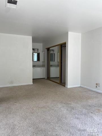 empty room with baseboards and visible vents