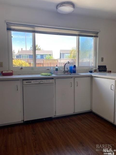 kitchen featuring a wealth of natural light, dishwasher, white cabinetry, and wood finished floors