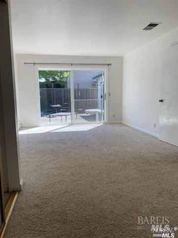 empty room with carpet flooring and visible vents