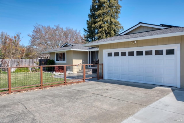 ranch-style house with a front lawn, driveway, a fenced front yard, a shingled roof, and a garage