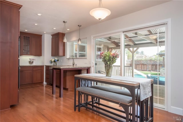 dining space with recessed lighting and light wood finished floors