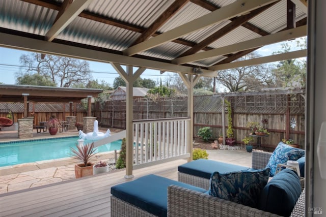 wooden terrace with a fenced in pool, a patio, and a fenced backyard