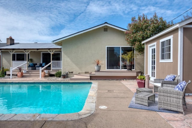 pool featuring outdoor lounge area and a patio area