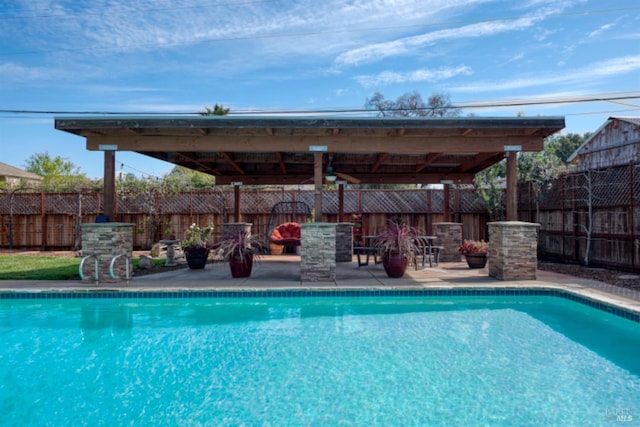 view of swimming pool featuring a fenced in pool, a patio, and a fenced backyard