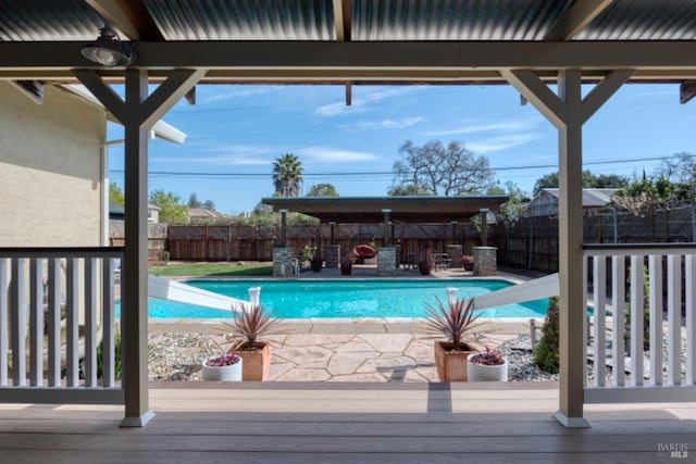 view of pool featuring a fenced in pool, a patio, a water slide, and a fenced backyard