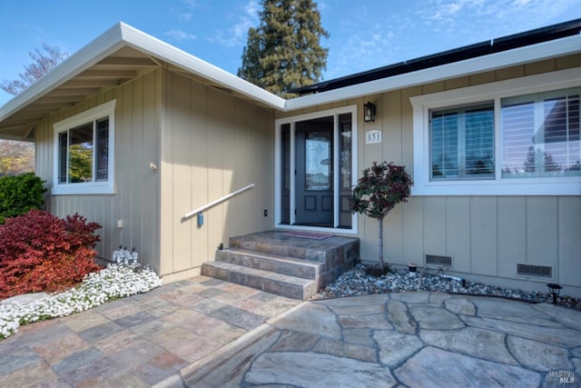 property entrance with a patio and visible vents