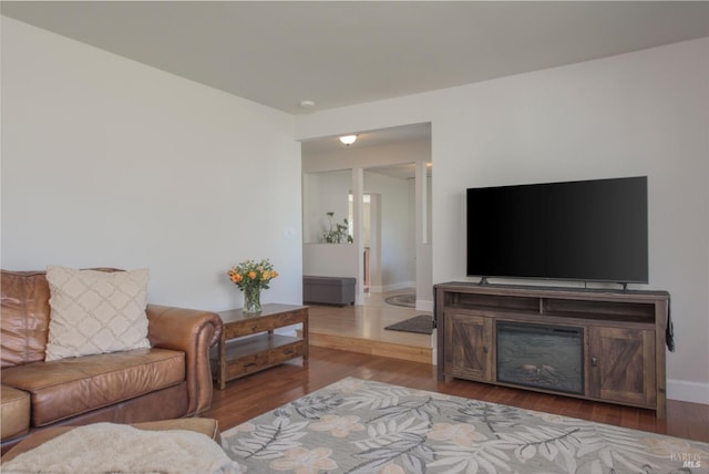 living area featuring baseboards and wood finished floors