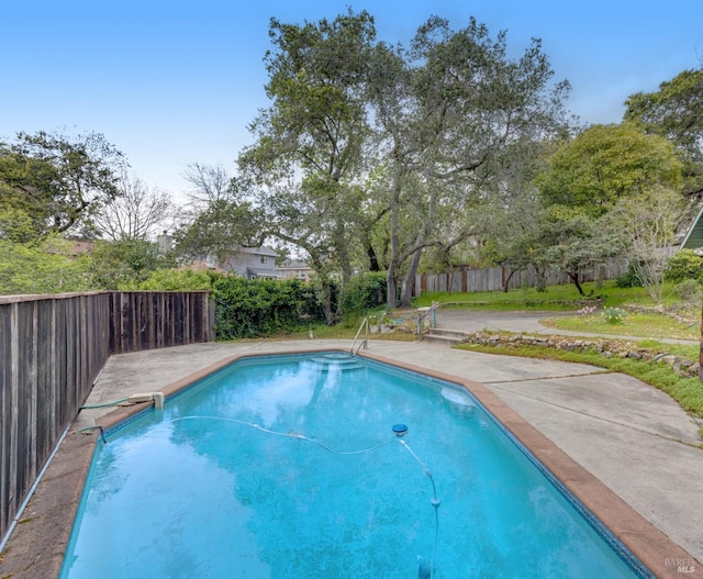 view of swimming pool featuring a patio area, a fenced in pool, and fence