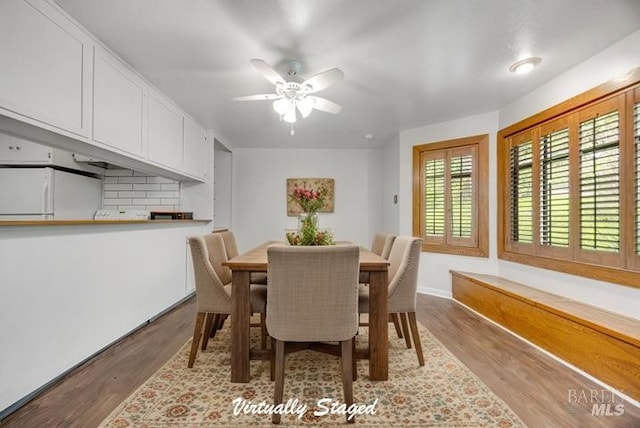 dining space featuring ceiling fan and wood finished floors