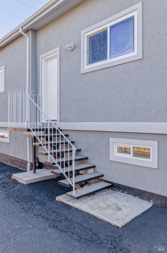 view of exterior entry with stucco siding