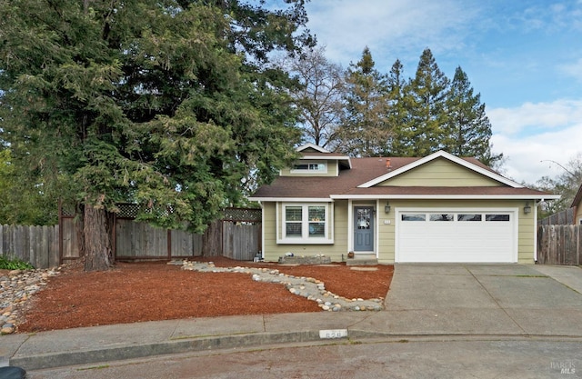 view of front of home with an attached garage, a shingled roof, driveway, and fence