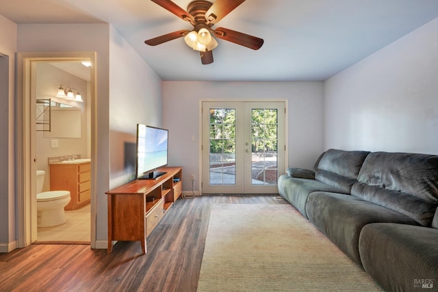 living room featuring french doors, baseboards, wood finished floors, and a ceiling fan