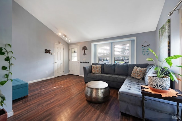 living area featuring baseboards, lofted ceiling, and wood finished floors