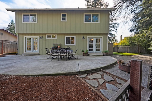 back of property featuring a patio area, french doors, and a fenced backyard