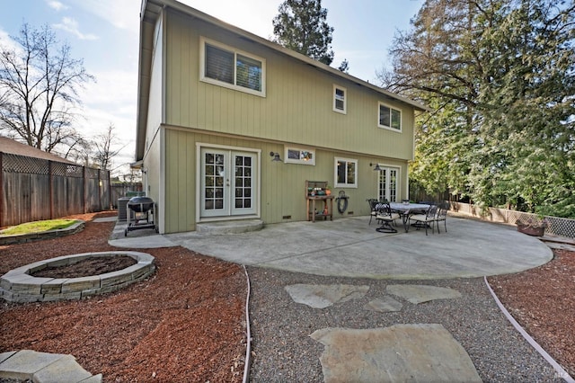 rear view of house featuring french doors, a patio, and a fenced backyard