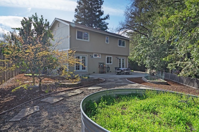 back of house featuring french doors, a patio, and a fenced backyard