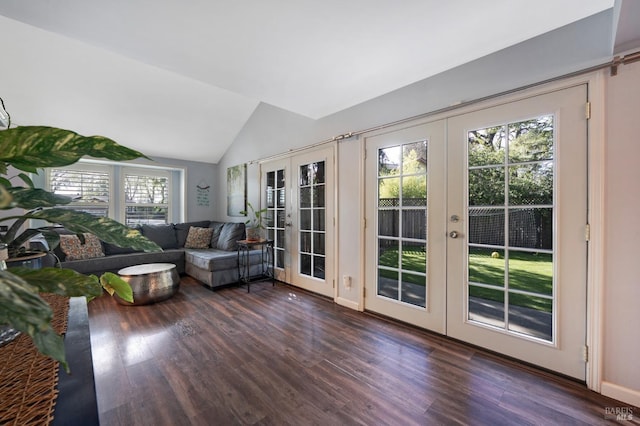 living area with dark wood-style flooring, french doors, and vaulted ceiling