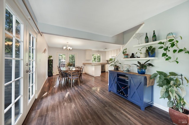 dining area with baseboards, dark wood-type flooring, and an inviting chandelier