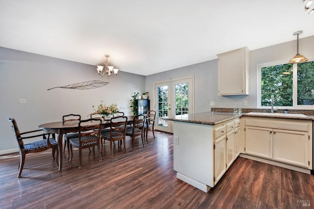 kitchen featuring a peninsula, dark wood-style floors, french doors, and a sink